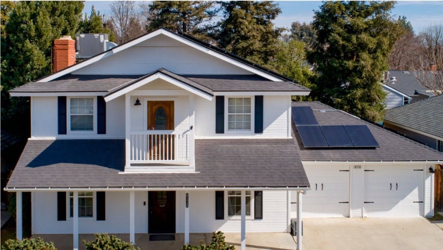 Modern two-story suburban townhouse, with a white exterior, and two-car garage