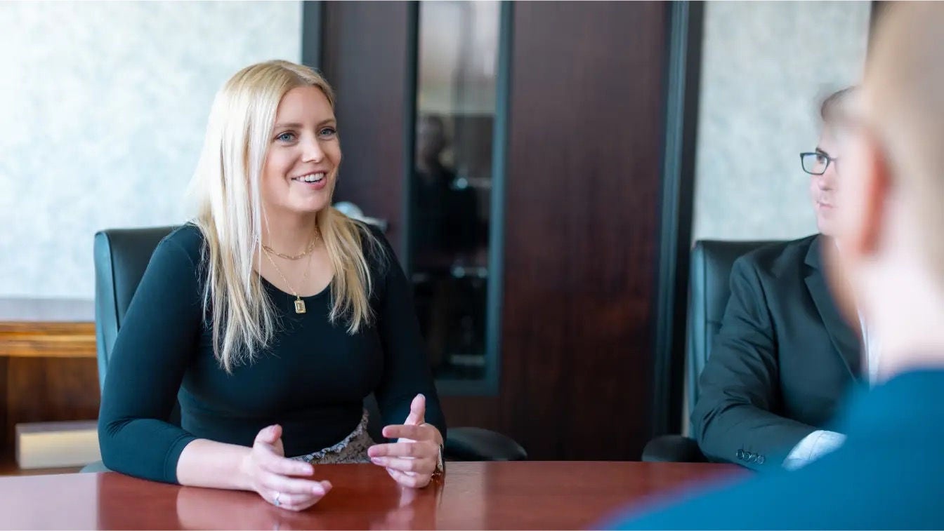 A group of people having a conversation around a conference table