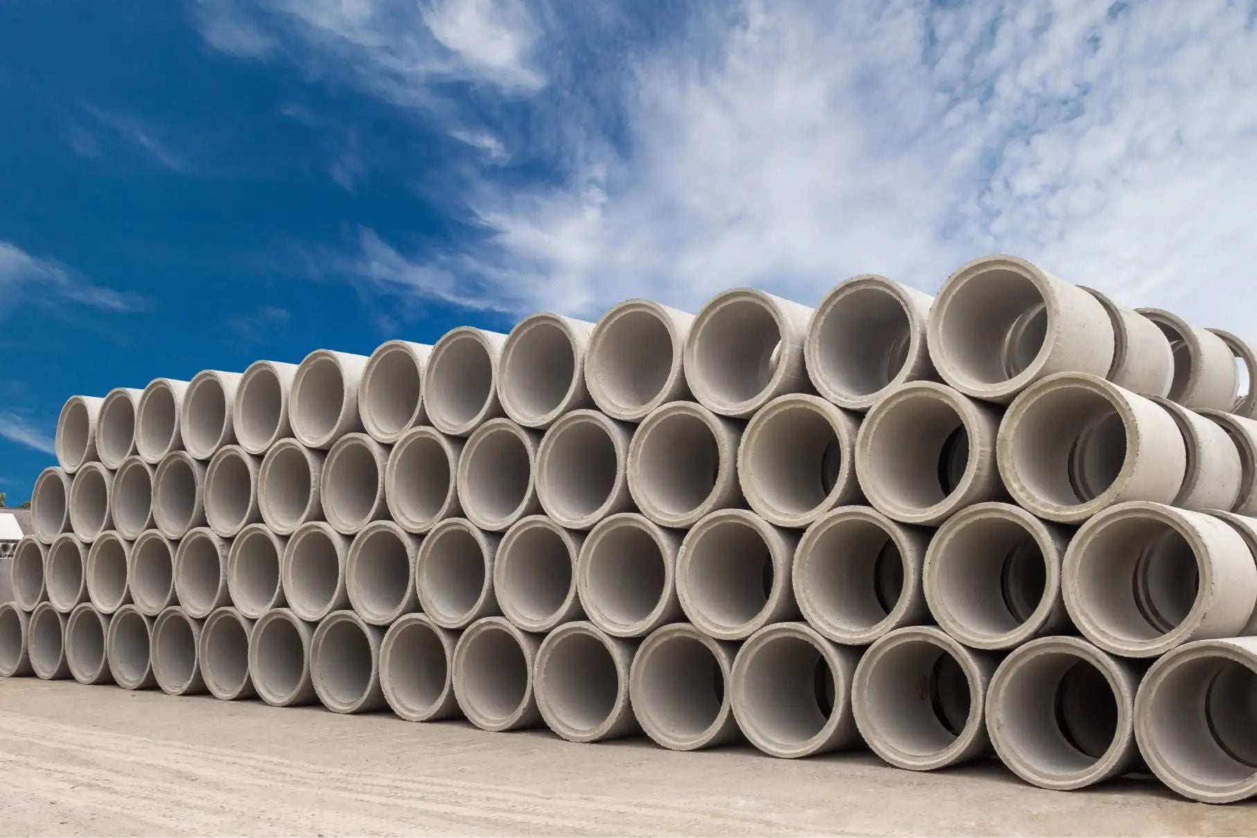 A large stack of precast concrete pipe