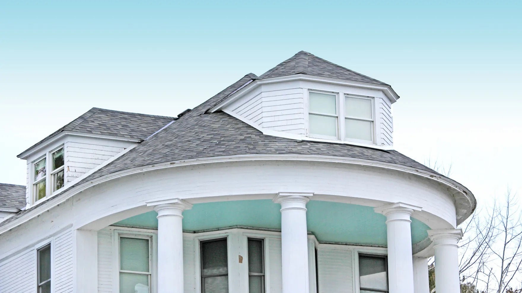 A rounded section of roof and overhang supported by columns