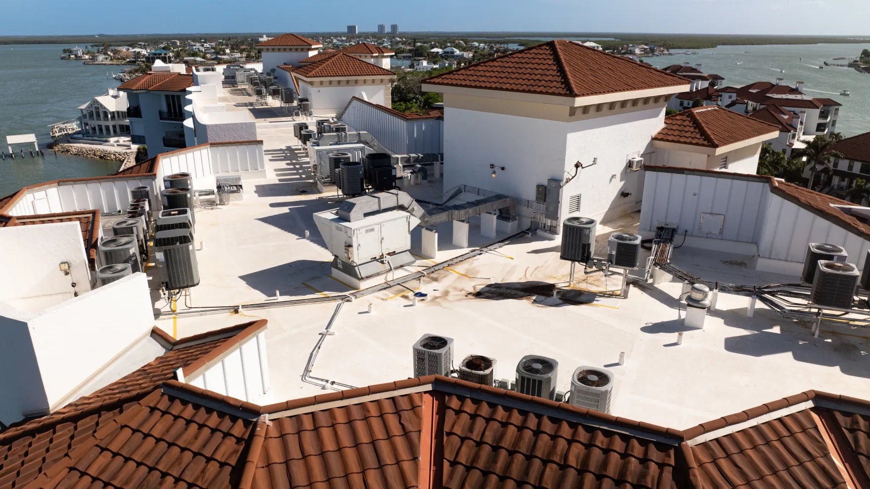 The rooftops of the Twin Dolphins condominiums with the coastline in the background