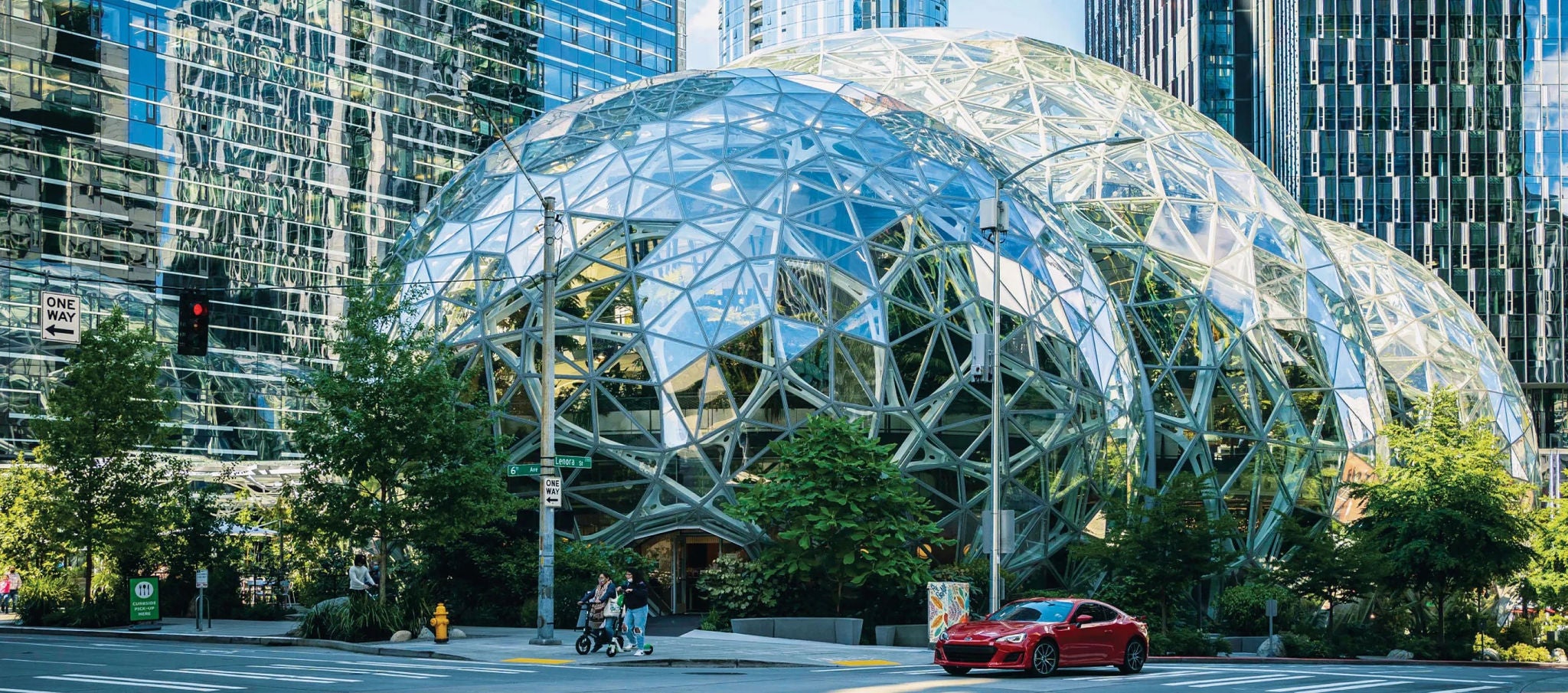  Street view of the Spheres with a glass design, surrounded by skyscrapers, trees, and automobiles