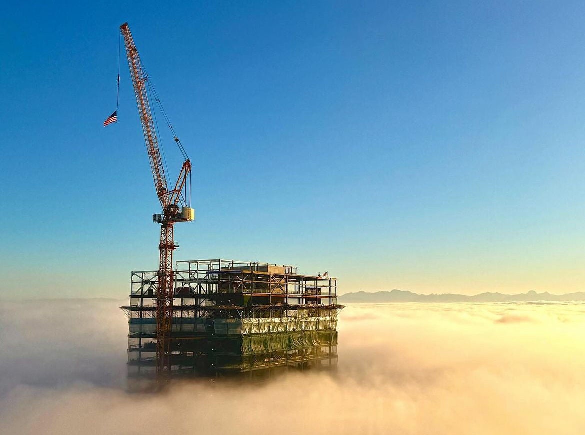 A construction worker looking out over a large building site