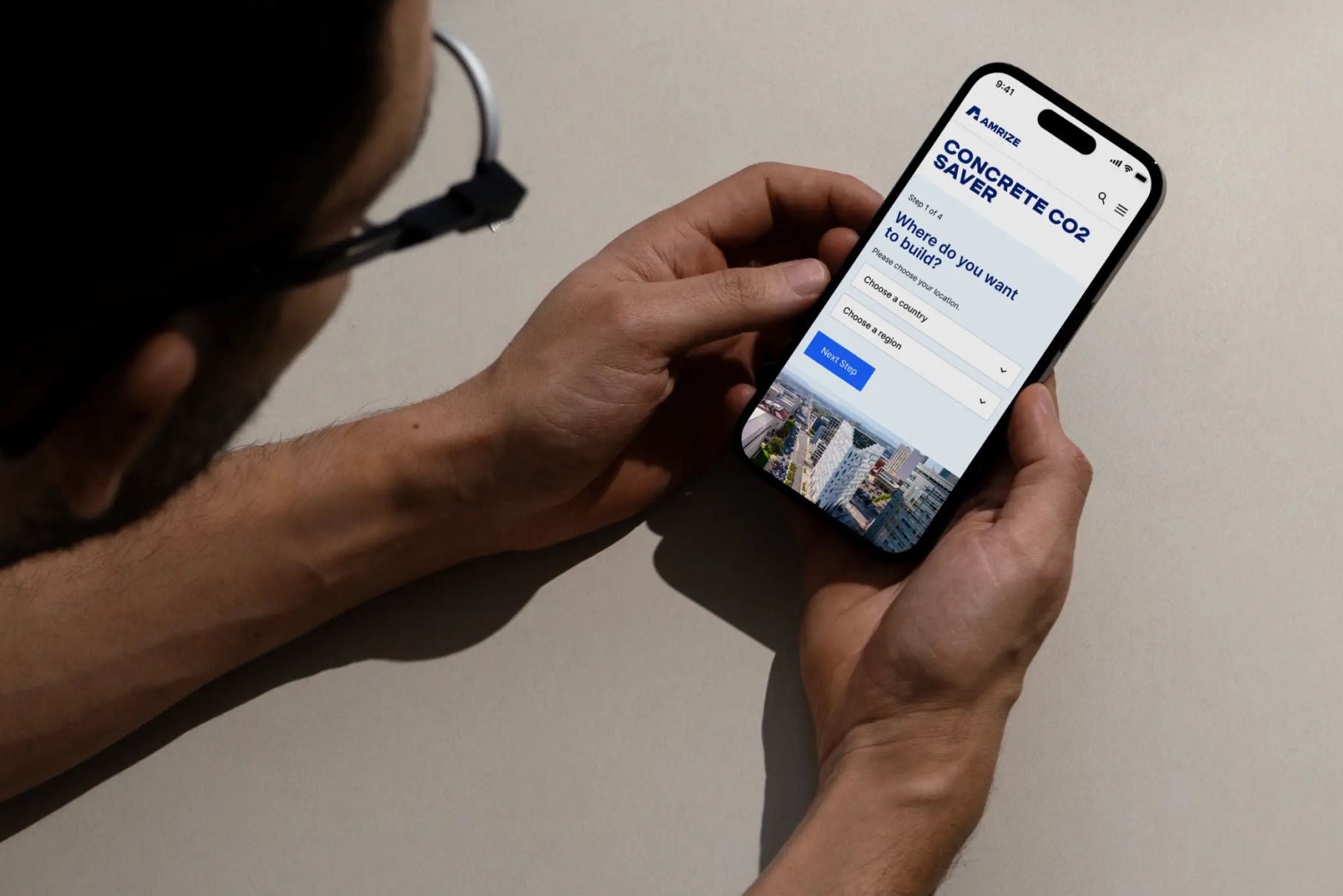 A person viewing the CO₂ Saver Calculator on their smartphone